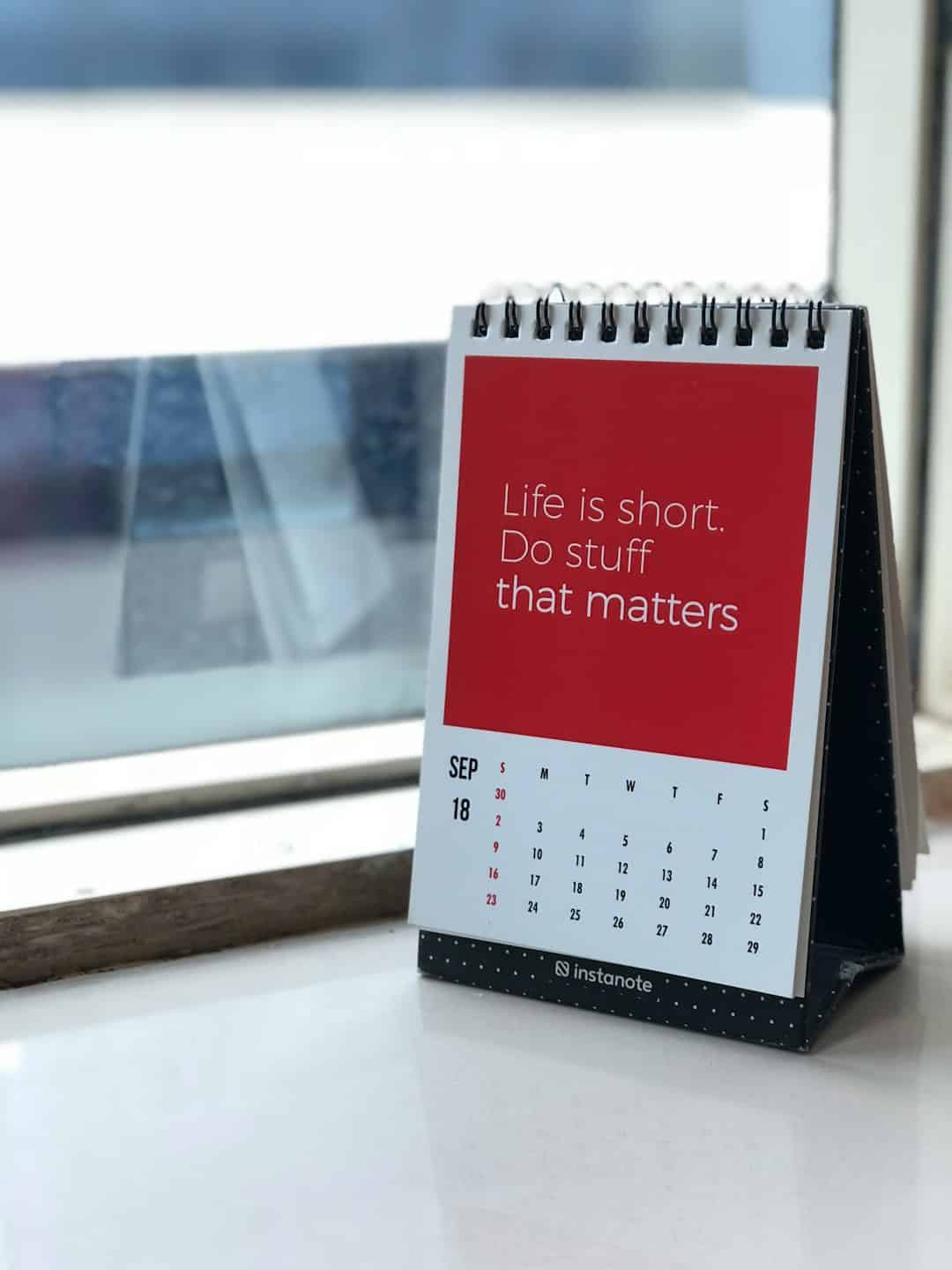 spiral freestanding calendar on white surface with the quote Life is short. Do stuff that matters